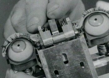 A photo of a hand holding the mechanical eyes of humanoid machine.