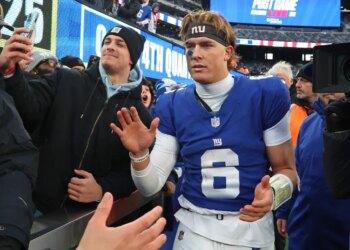 New York Giants quarterback Jaxson Dart (6) high-fives fans after a game.