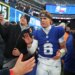 New York Giants quarterback Jaxson Dart (6) high-fives fans after a game.