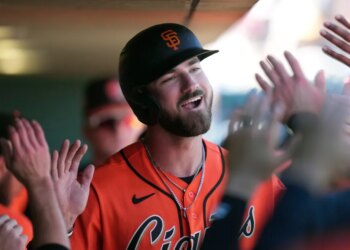 Bryce Eldridge of the San Francisco Giants smiles and celebrates with teammates.