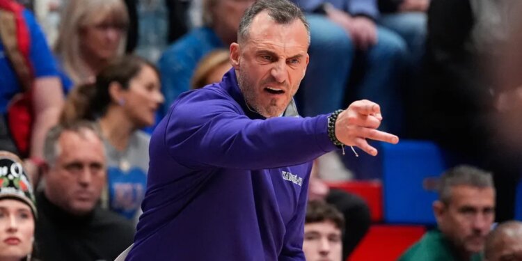 Green Bay head coach Doug Gottlieb motions to his players during an NCAA college basketball game against Kansas.