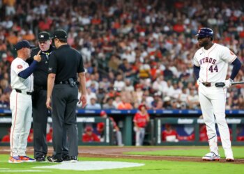 Houston Astros manager Joe Espada argues with home plate umpire Chris Conroy while designated hitter Yordan Alvarez looks on.