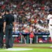 Houston Astros manager Joe Espada argues with home plate umpire Chris Conroy while designated hitter Yordan Alvarez looks on.