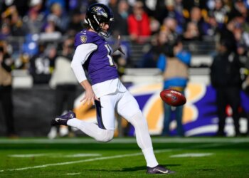 Baltimore Ravens punter Jordan Stout kicking the football.