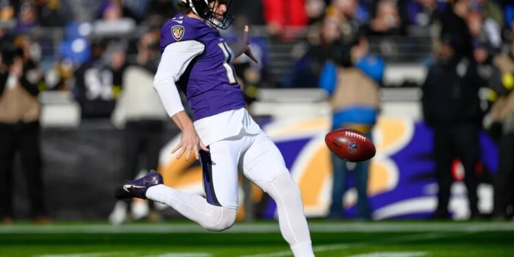 Baltimore Ravens punter Jordan Stout kicking the football.
