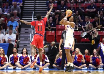 St. John's Red Storm player Ian Jackson jumps to block a shot by Kansas Jayhawks player Darryn Peterson during the NCAA Tournament.