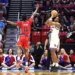 St. John's Red Storm player Ian Jackson jumps to block a shot by Kansas Jayhawks player Darryn Peterson during the NCAA Tournament.