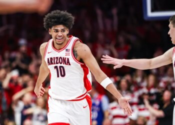 Koa Peat (10) celebrates for Arizona during a basketball game.
