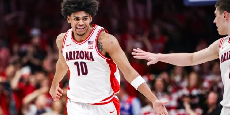 Koa Peat (10) celebrates for Arizona during a basketball game.