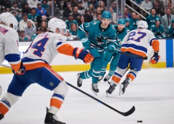 Jean-Gabriel Pageau (44) skates the puck up ice as Michael Misa (77) forechecks during the Islanders' 2-1 overtime win over the Sharks on March 7, 2026 in San Jose, Calif.