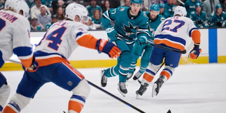 Jean-Gabriel Pageau (44) skates the puck up ice as Michael Misa (77) forechecks during the Islanders' 2-1 overtime win over the Sharks on March 7, 2026 in San Jose, Calif.