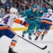 Jean-Gabriel Pageau (44) skates the puck up ice as Michael Misa (77) forechecks during the Islanders' 2-1 overtime win over the Sharks on March 7, 2026 in San Jose, Calif.