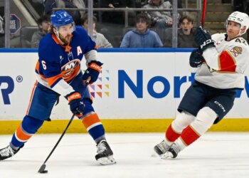 Ryan Pulock attempts a pass as Gustav Forsling defends during the Islanders 5-4 win over the Panthers on March 2, 2026.