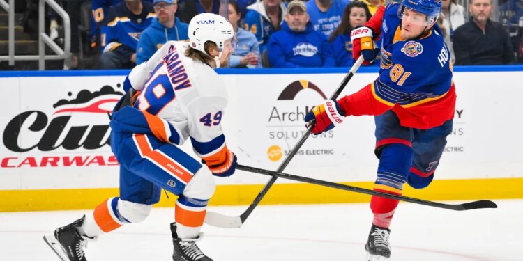 Dylan Holloway shoots and scores as Max Shabanov defends during the Islanders' win overt the Blues on March 10, 2026.