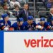 New York Islanders head coach Patrick Roy observes from the bench as players watch the game.