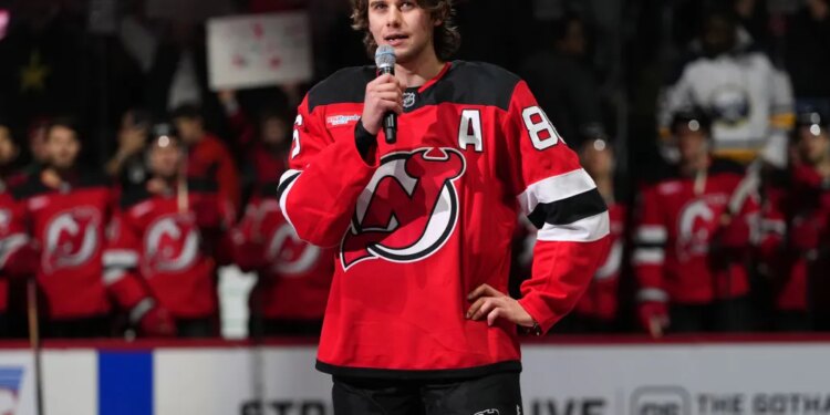 New Jersey Devils' Jack Hughes speaks to fans before an NHL hockey game against the Buffalo Sabres Wednesday, Feb. 25, 2026, in Newark, N.J.
