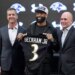 Odell Beckham Jr. holds up a Ravens jersey with head coach John Harbaugh and general manager Eric DeCosta at a news conference.