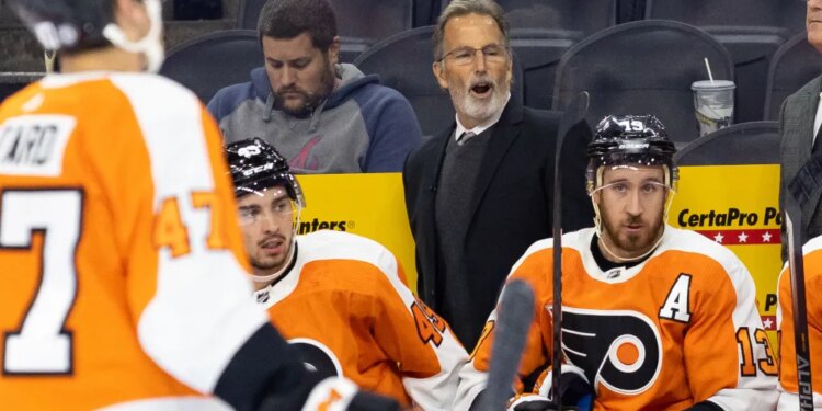 Philadelphia Flyers head coach John Tortorella speaks to his players on the bench.