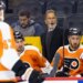 Philadelphia Flyers head coach John Tortorella speaks to his players on the bench.