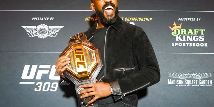 UFC Heavyweight Champion Jon Jones holding his championship belt.