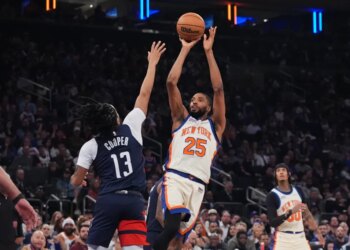 Mikal Bridges (25) of the Knicks shoots over the Wizards' Sharife Cooper (13) on March 22, 2026.
