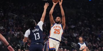 Mikal Bridges (25) of the Knicks shoots over the Wizards' Sharife Cooper (13) on March 22, 2026.