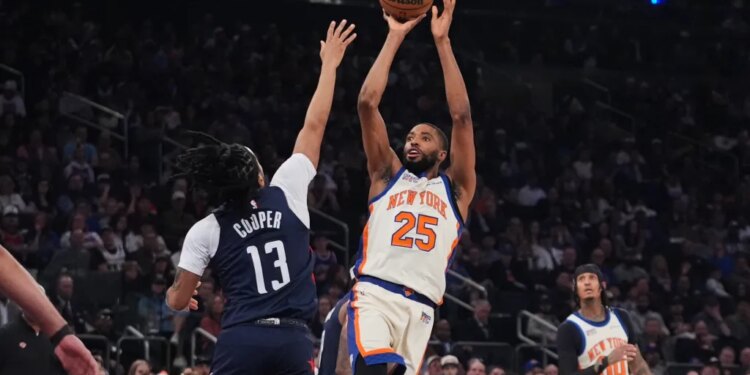 Mikal Bridges (25) of the Knicks shoots over the Wizards' Sharife Cooper (13) on March 22, 2026.