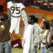 Bryan Pata's family holds up his jersey at the beginning of an NCAA college football game between Miami and Boston College.