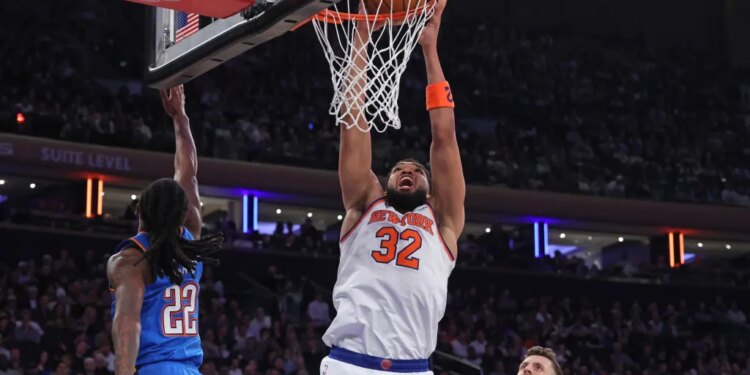 New York Knicks center Karl-Anthony Towns (32) dunks the ball during a game against the Oklahoma City Thunder.
