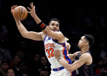 Karl-Anthony Towns, who scored 26 points and grabbed 15 rebounds, looks to make a move on Josh Minott during the Knicks' 93-92 win over the Nets on March 20, 2026 at Barclays Center.