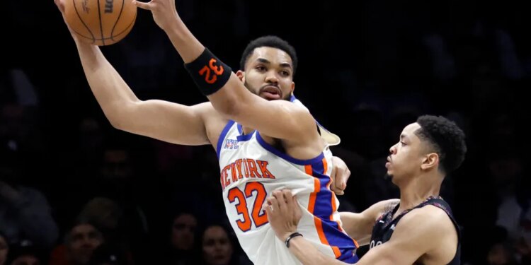 Karl-Anthony Towns, who scored 26 points and grabbed 15 rebounds, looks to make a move on Josh Minott during the Knicks' 93-92 win over the Nets on March 20, 2026 at Barclays Center.