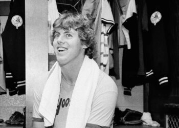 Ken Clay smiling in the dressing room after a Yankees victory.