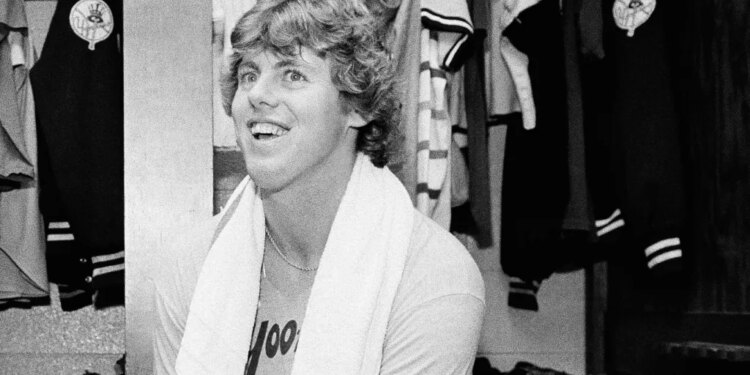 Ken Clay smiling in the dressing room after a Yankees victory.