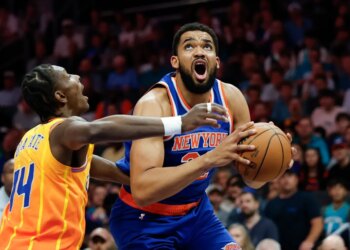 Karl-Anthony Towns of the New York Knicks prepares to shoot against Moussa Diabate of the Charlotte Hornets.
