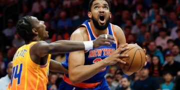 Karl-Anthony Towns of the New York Knicks prepares to shoot against Moussa Diabate of the Charlotte Hornets.