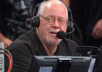 Los Angeles Lakers announcer Lawrence Tanter wearing headphones and a microphone.