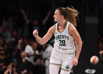Sabrina Ionescu reacting after scoring a three-point basket during a game.