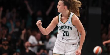 Sabrina Ionescu reacting after scoring a three-point basket during a game.