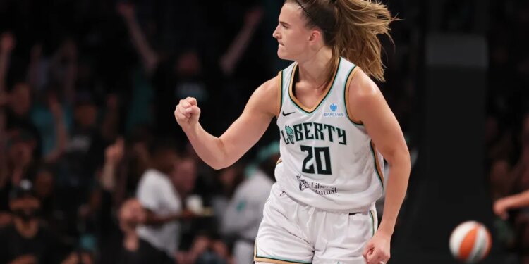 Sabrina Ionescu reacting after scoring a three-point basket during a game.