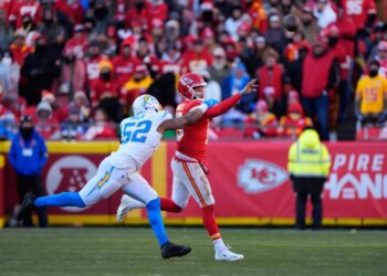 Kansas City Chiefs quarterback Patrick Mahomes throws the ball while Los Angeles Chargers outside linebacker Khalil Mack pressures him.