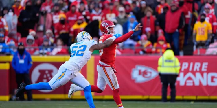 Kansas City Chiefs quarterback Patrick Mahomes throws the ball while Los Angeles Chargers outside linebacker Khalil Mack pressures him.