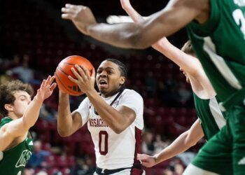 UMass guard Danny Carbuccia is surrounded by Ohio defenders during a basketball game.