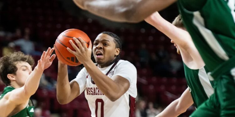 UMass guard Danny Carbuccia is surrounded by Ohio defenders during a basketball game.