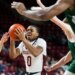UMass guard Danny Carbuccia is surrounded by Ohio defenders during a basketball game.