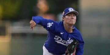 Dodgers pitcher Yoshinobu Yamamoto throws a pitch during a spring training game.
