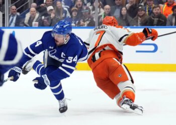 Toronto Maple Leafs Auston Matthews (34) is injured by Anaheim Ducks Radko Gudas (7) during a hockey game.