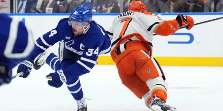Toronto Maple Leafs Auston Matthews (34) is injured by Anaheim Ducks Radko Gudas (7) during a hockey game.