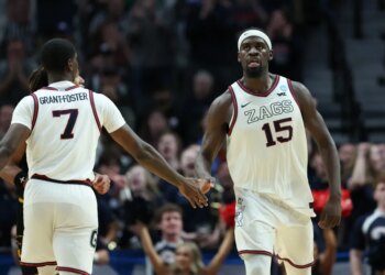 Gonzaga forward Graham Ike (15) reacts with guard Tyon Grant-Foster after a play during the second half of an NCAA college basketball tournament game.