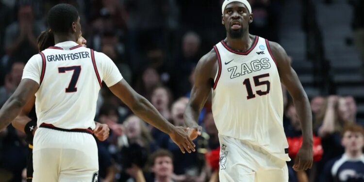 Gonzaga forward Graham Ike (15) reacts with guard Tyon Grant-Foster after a play during the second half of an NCAA college basketball tournament game.