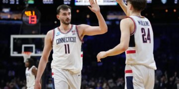 Alex Karaban and Braylon Mullins high-five during a UConn game.